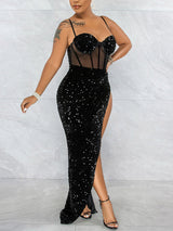 Back view of a woman in a black sequined maxi dress with a high slit