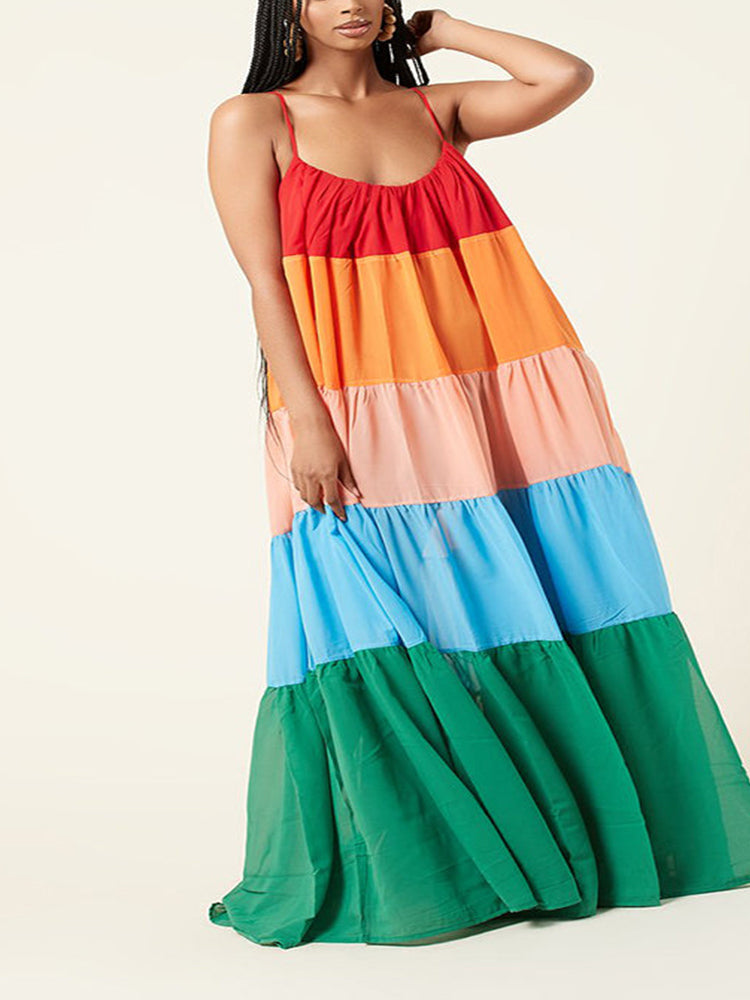 Woman in a red, orange, pink, blue, and green tiered maxi dress.