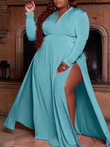 woman wearing a long teal maxi dress with a high slit and long sleeves, showing her hair