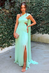 woman in a mint green one-shoulder pleated gown with a high slit and cut-out detail