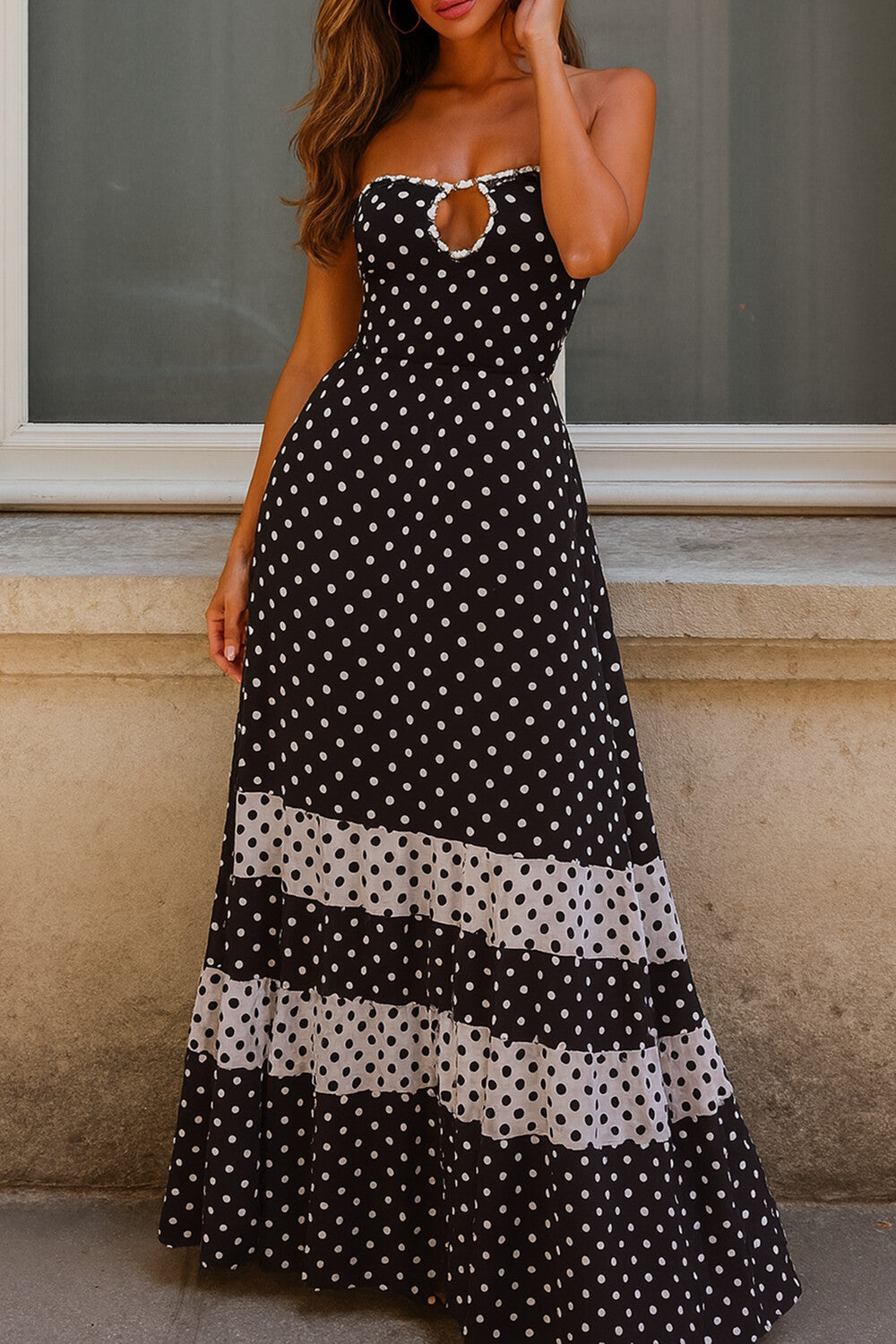 woman wearing a black and white polka dot maxi dress