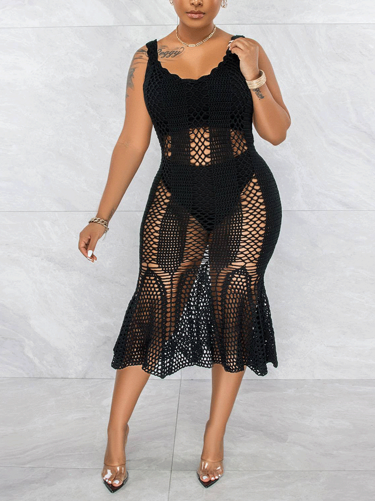 Woman wearing a black sleeveless crochet knit mermaid dress with a scoop neck.