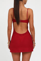 Detail shot of the red embellished mini dress, focusing on the floral pattern and sheer mesh.