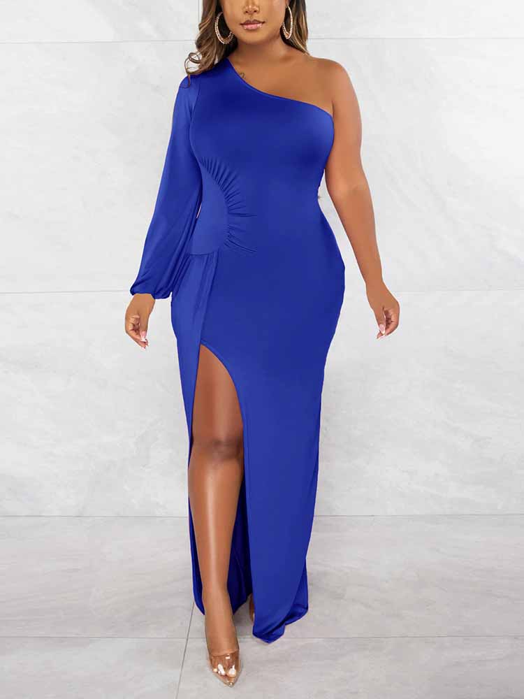 Woman wearing a royal blue one-shoulder maxi dress with a high slit and long sleeve.