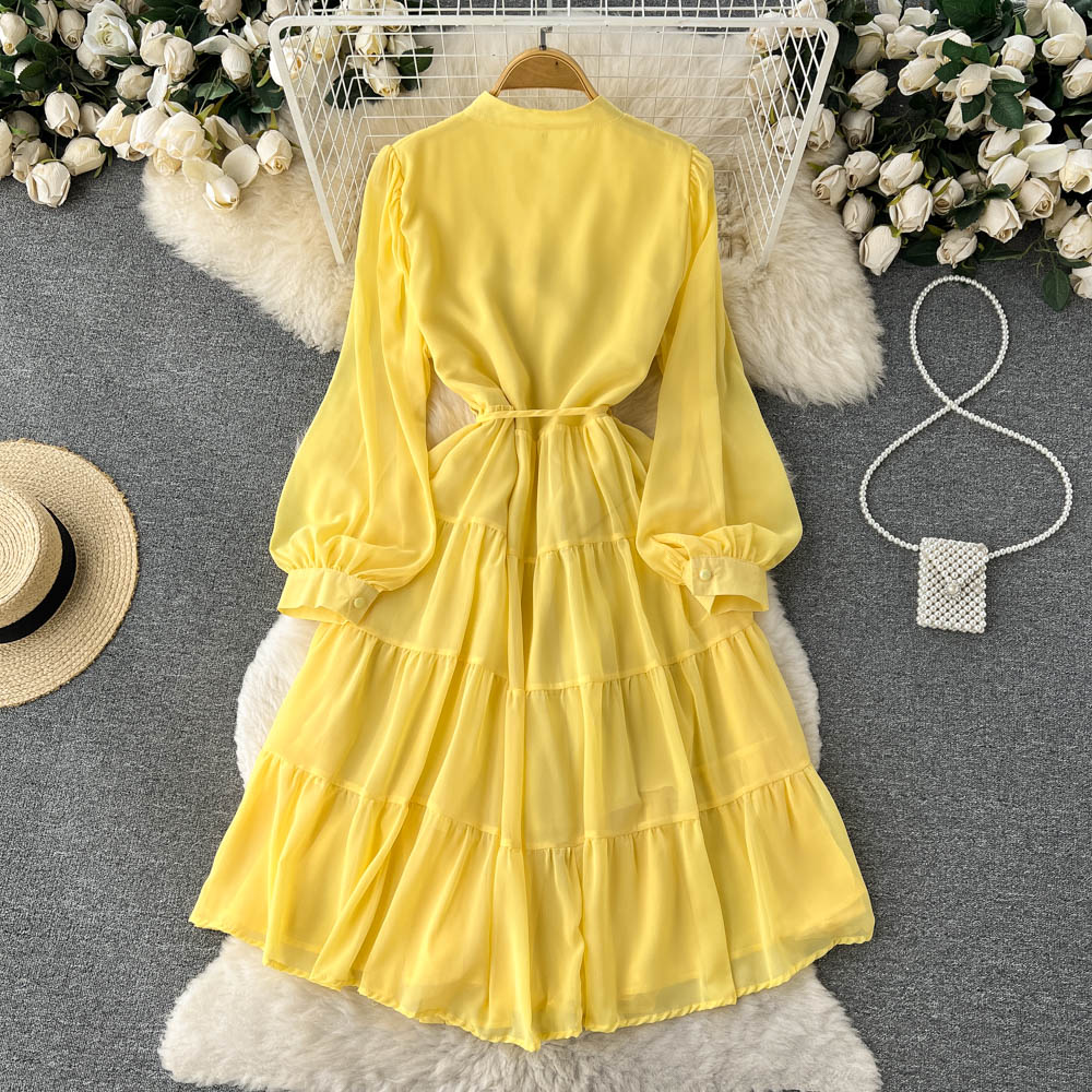 A woman wearing a chic pleated maxi dress with a tiered skirt and puff sleeves. - View 6 | Lwiis