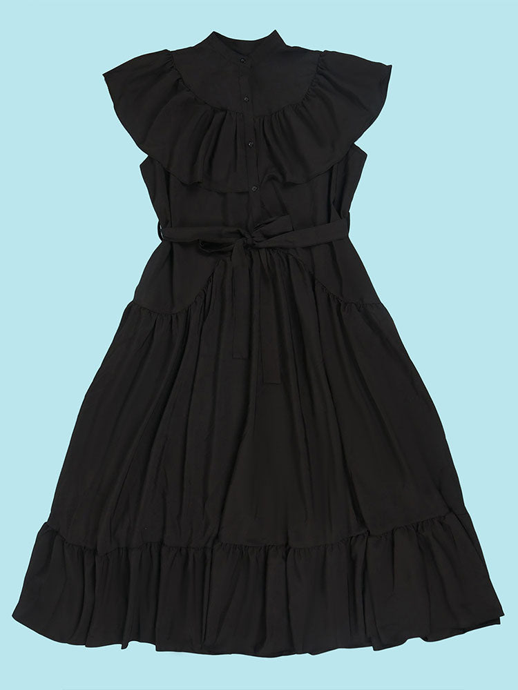 Flat lay of a black maxi dress with ruffled neckline and tiered skirt.