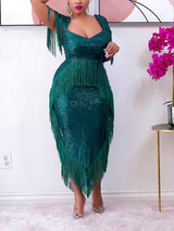 Full-body shot of a woman in a green sequined fringe dress.