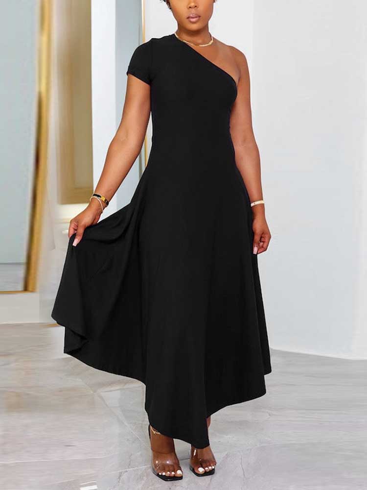 Front view of a woman in a black one-shoulder midi dress, with her hand touching the skirt.