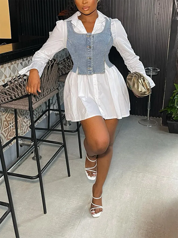Woman in a white collared shirt dress with a denim vest overlay and white sandals