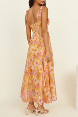 side view of a woman in a floral print midi dress, highlighting the flowing skirt