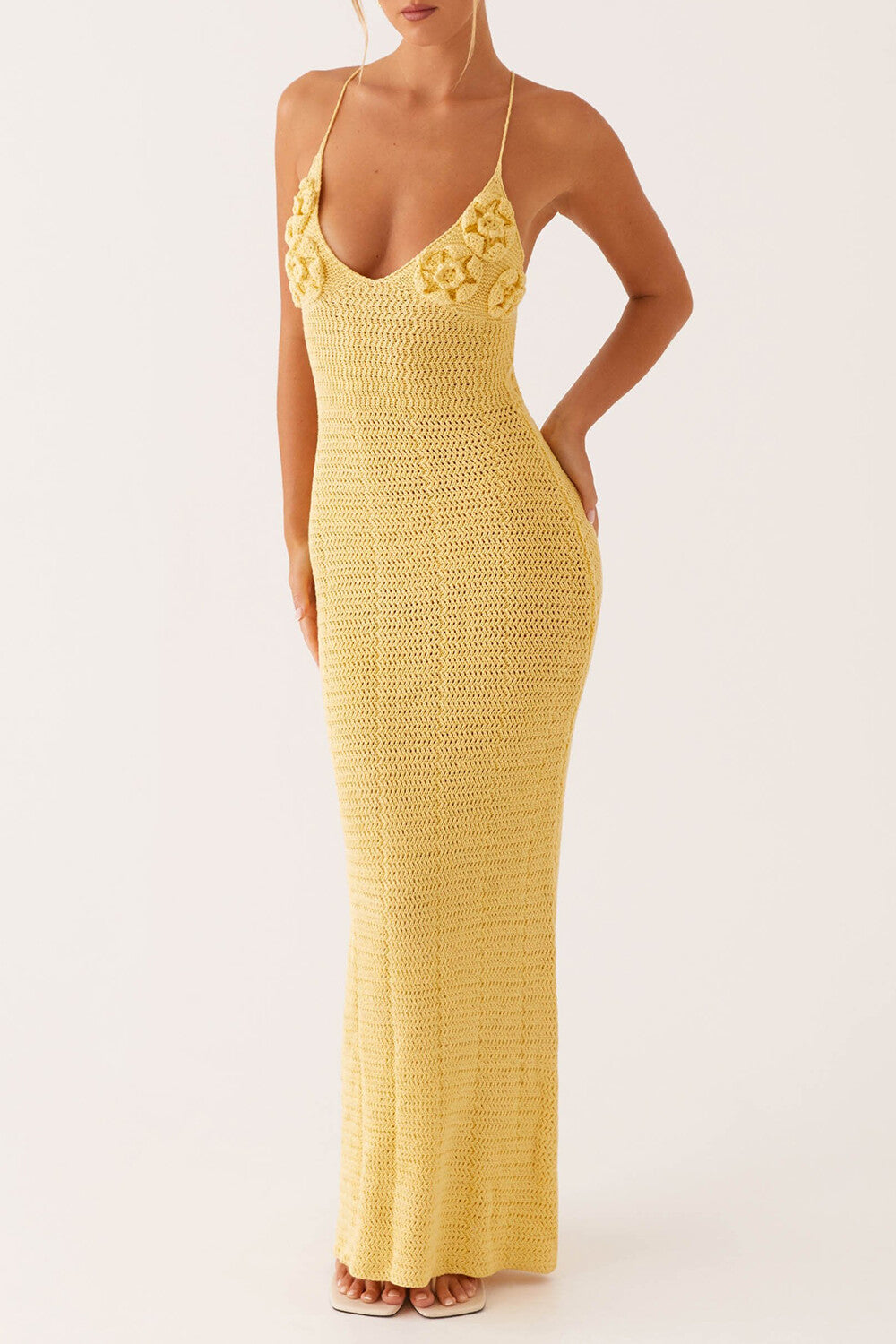 full body shot of a woman wearing a yellow crochet knit maxi dress