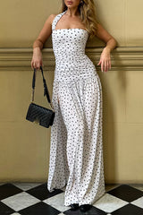 woman wearing white polka dot maxi dress with high slit and halter neckline