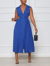 woman holding a black handbag while wearing a royal blue sleeveless midi dress with cut-out sides and a collared v-neckline