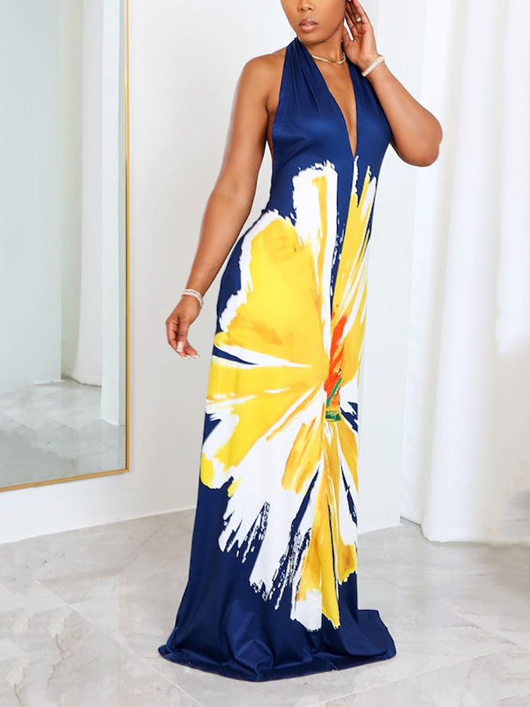 Side view of a woman modeling a navy blue halter maxi dress with a vibrant floral print.