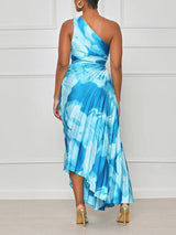 Woman wearing a blue tie-dye one-shoulder pleated maxi dress from the back.