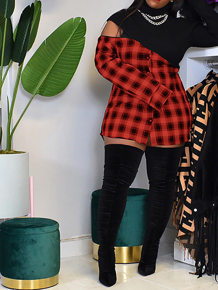 Woman wearing a black and red plaid mini dress with a black knit top and thigh-high black boots, posing