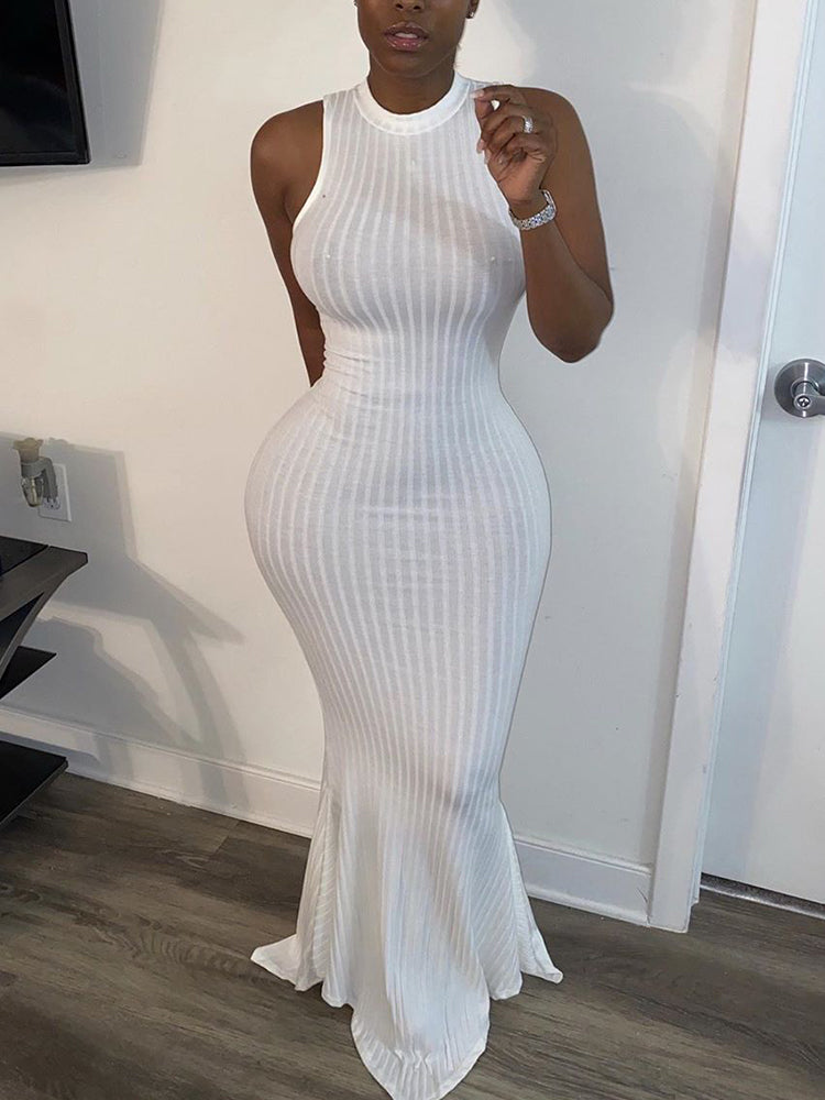 Woman wearing a white sleeveless ribbed knit maxi dress with a mermaid hem and mock neckline.