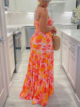 Back view of a woman in a strapless floral maxi dress