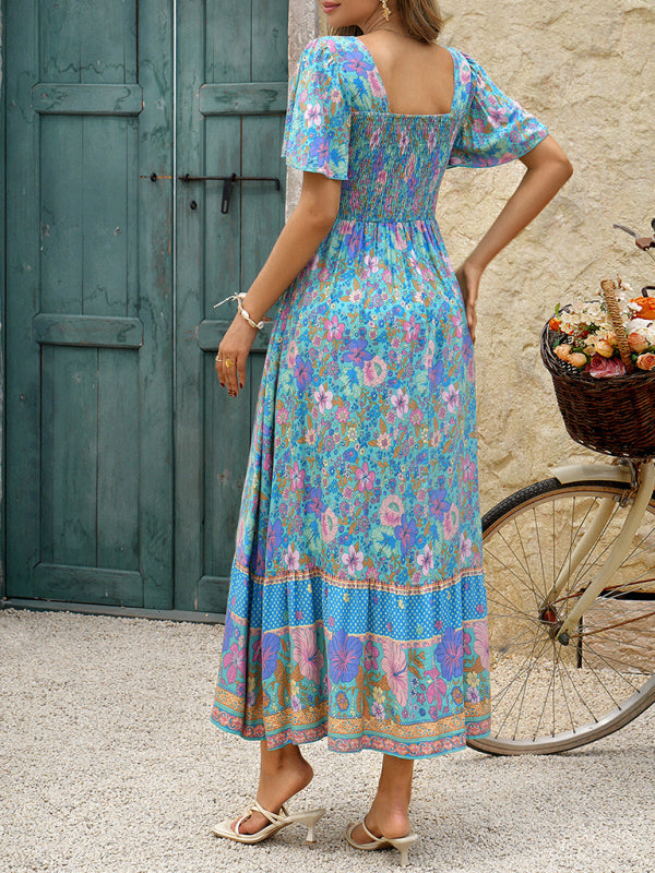 Back view of a woman in a blue floral print maxi dress with flutter sleeves and a square neckline.