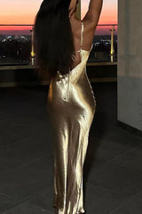 Back view of a woman in a gold slip dress showing the zipper closure