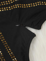 Close-up of the zipper and embellishments on a black long-sleeved dress.