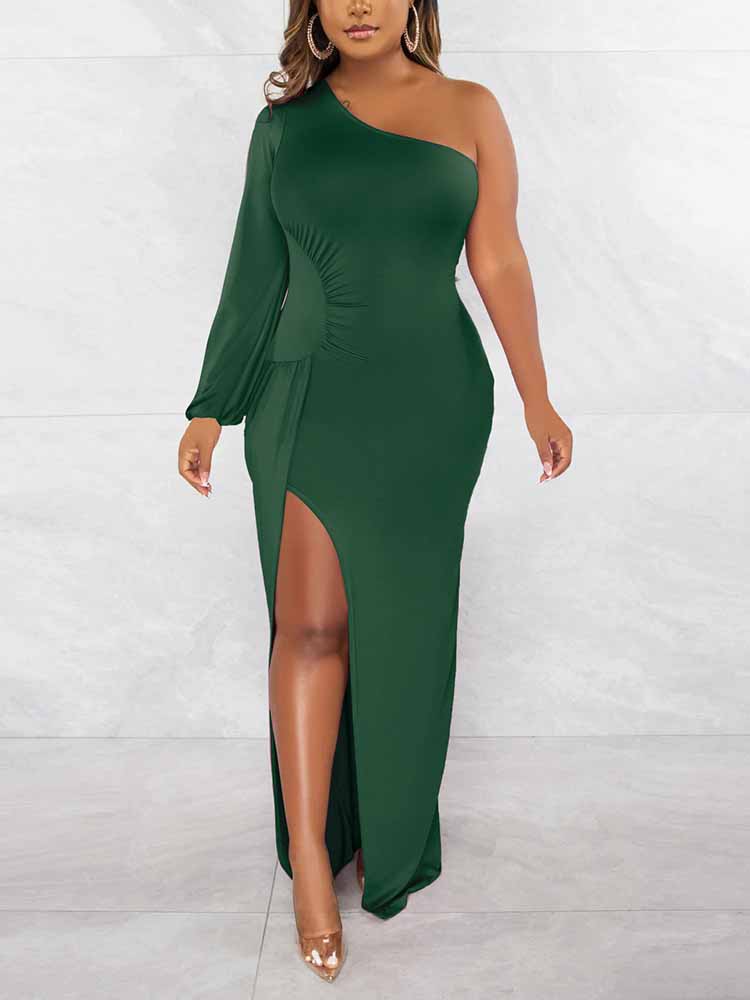 Woman wearing a dark green one-shoulder maxi dress with a high slit and long sleeve.
