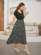 Woman in a floral print midi dress holding a straw bag.