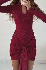 Close-up of a maroon lace mini dress with a keyhole neckline and long sleeves.
