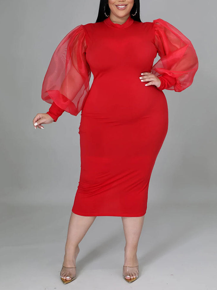 Plus-size woman wearing a red mock neck sheath dress with sheer puff sleeves and a slit hem, front view