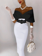 Woman in a black off-the-shoulder top and white pencil skirt with white sheer gloves and a handbag.