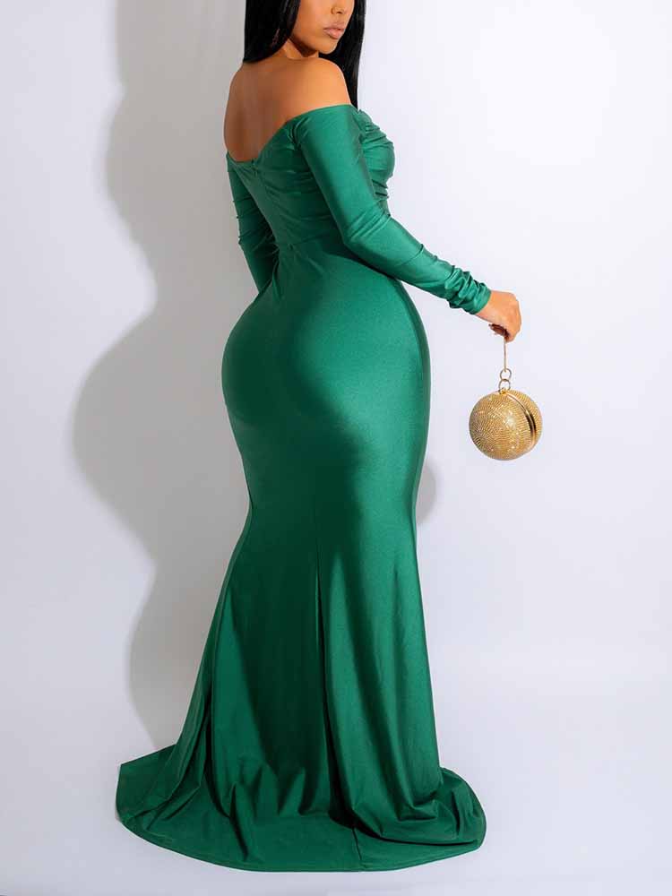 back view of a woman in a green off-the-shoulder formal gown