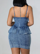 Rear view of a woman showcasing the back of a fitted denim dress.