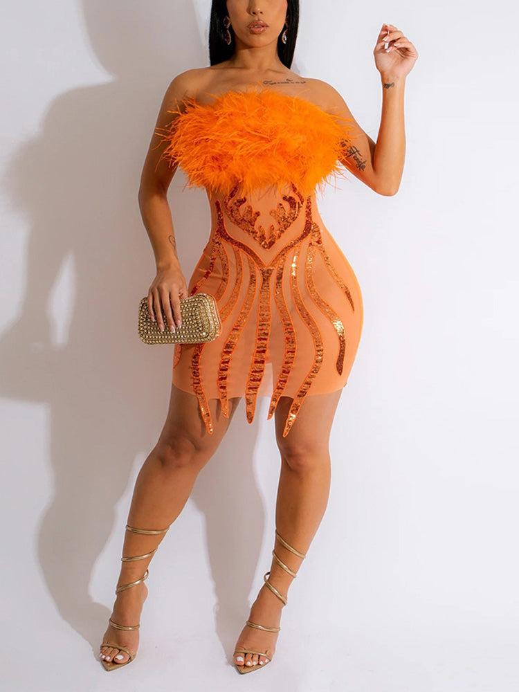 Woman wearing an orange strapless mini dress with feather trim and sequin details.