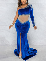 Detail shot of the embellished neckline and sleeve of a velvet gown