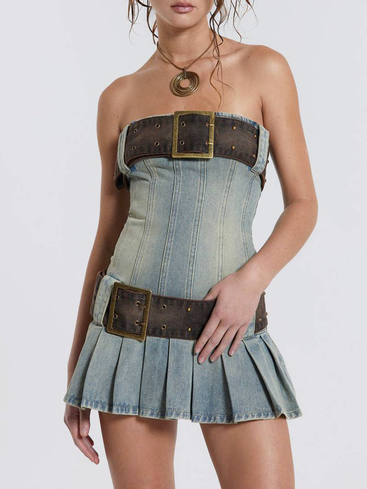 Studio shot of a strapless denim corset dress with brown belt details and a pleated skirt.