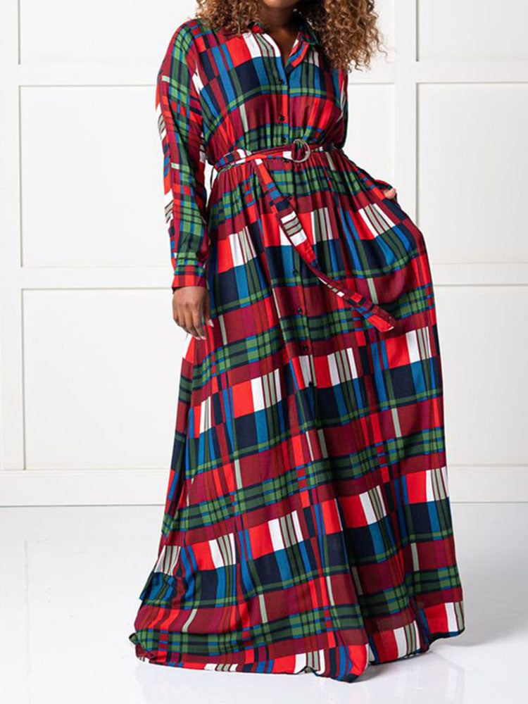 Woman wearing a belted plaid maxi dress with long sleeves, showing the full length of the dress