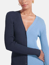 Close-up of a woman's chest and arms wearing a navy and light blue color-block ribbed knit midi dress