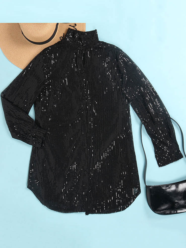 flat lay of a black sequin shirt dress next to a straw hat and a black handbag
