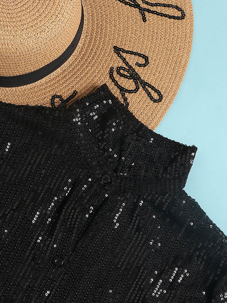 close-up of the collar and button details of a black sequin shirt