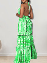 Back view of a woman in a green tie-dye halter neck maxi dress