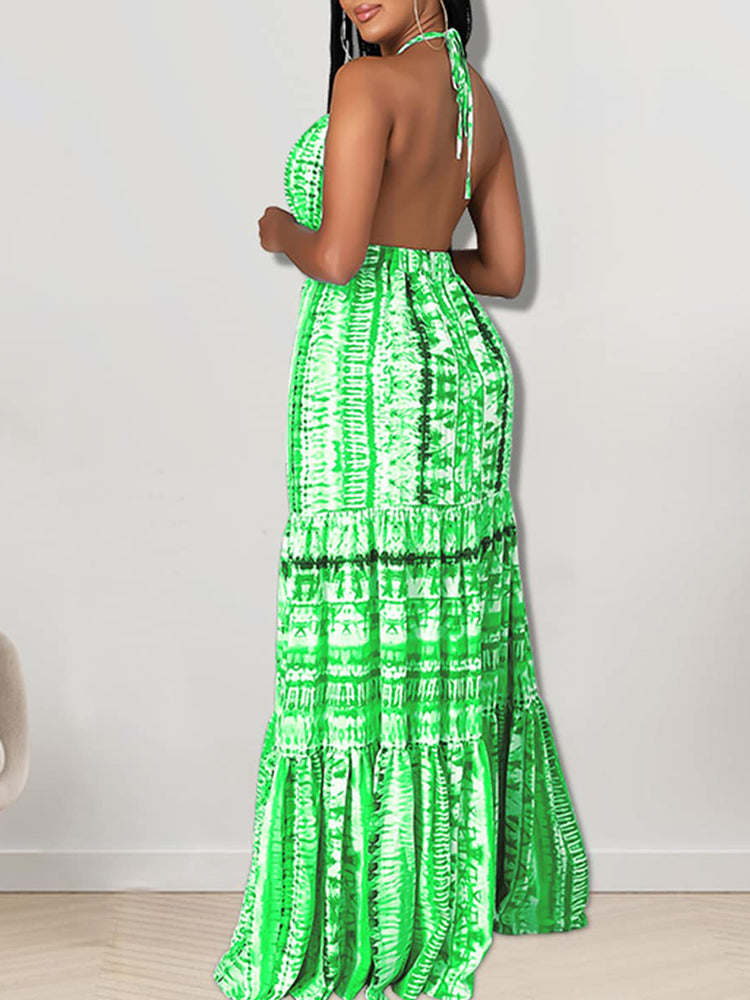 Back view of a woman in a green tie-dye halter neck maxi dress
