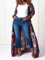 Woman wearing a long plaid duster over dark wash jeans and a white top