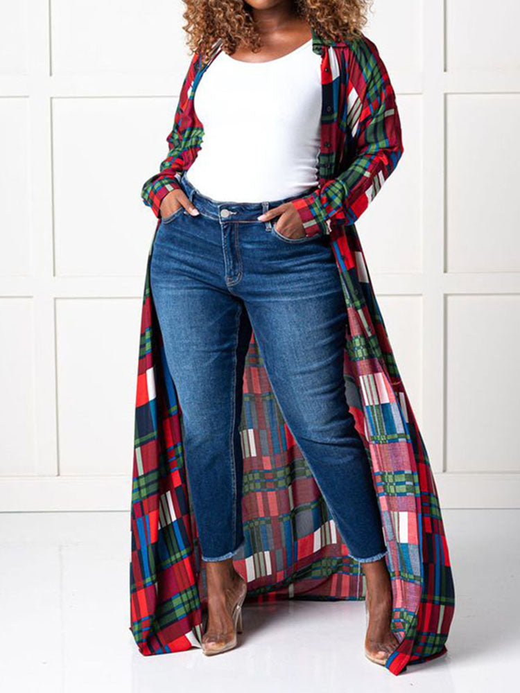 Woman wearing a long plaid duster over dark wash jeans and a white top