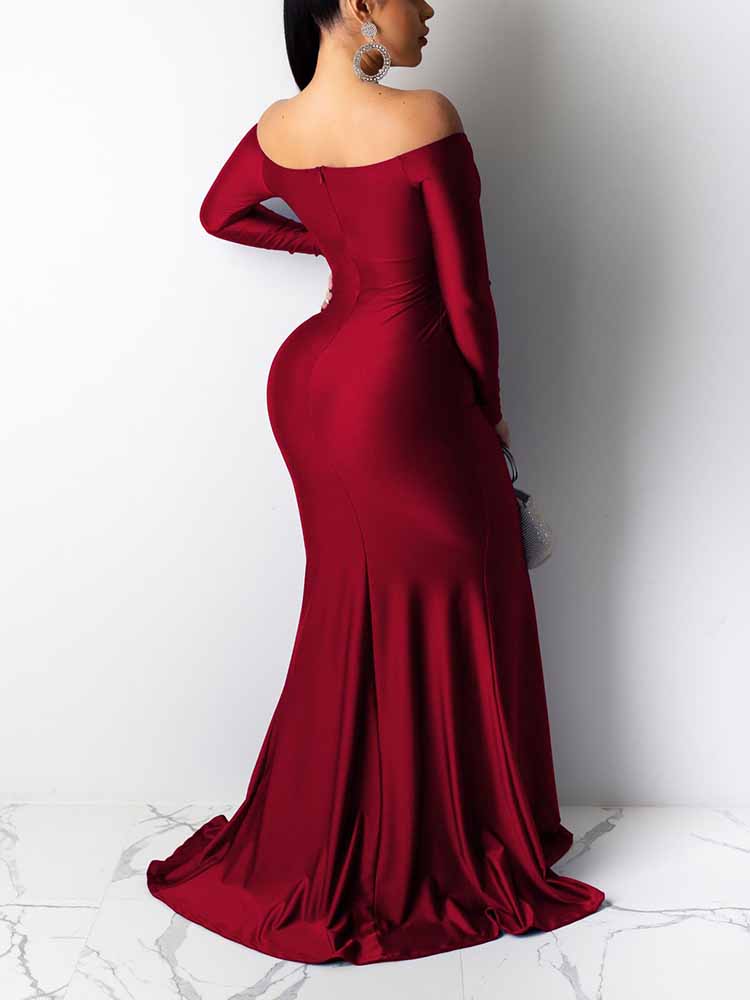 Back view of a woman in a long, off-the-shoulder, red satin dress with a mermaid skirt.