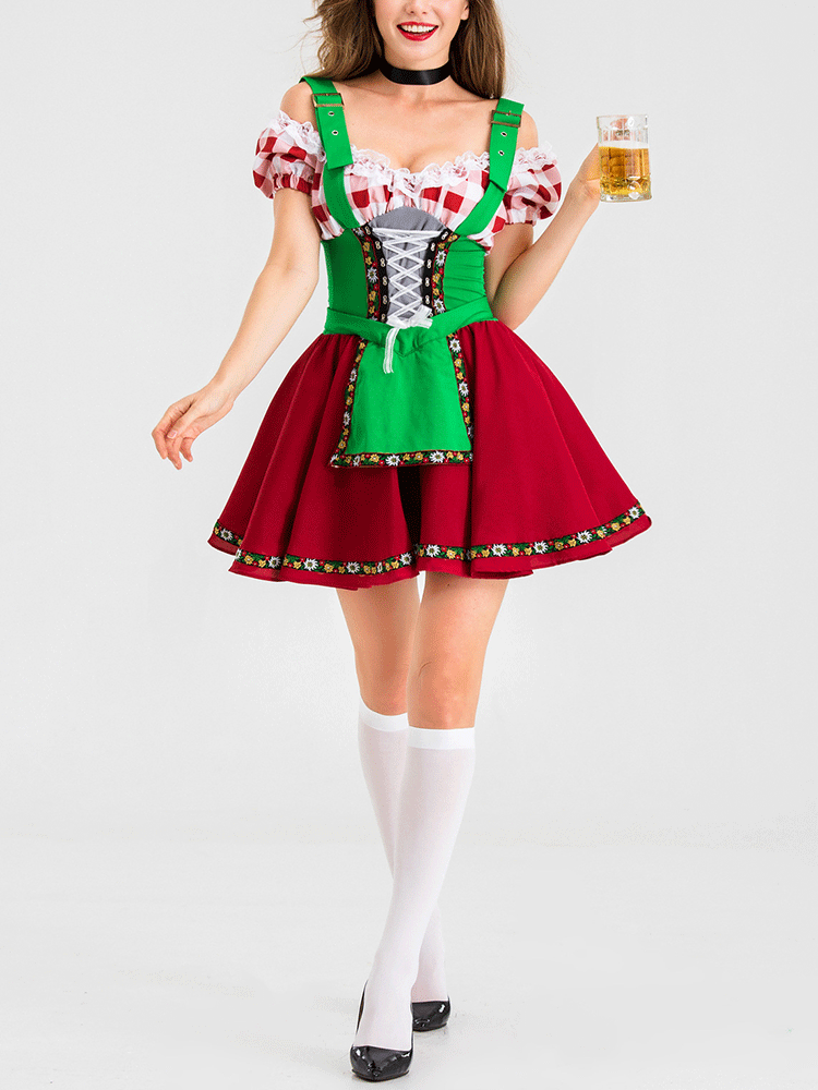Woman wearing a red and green dirndl-style costume with white knee-high socks and black heels, holding a glass of beer.