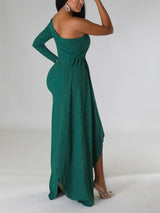 Side view of a woman showcasing the silhouette of a green asymmetrical sparkly dress