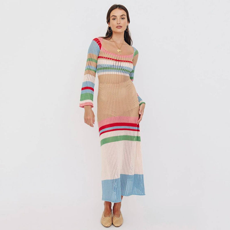 Woman wearing a long-sleeved, striped, crochet knit maxi dress with a square neckline.