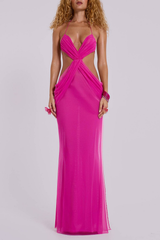 Woman wearing a vibrant pink sheer mesh maxi dress with a plunging halter neckline and cut-out details.