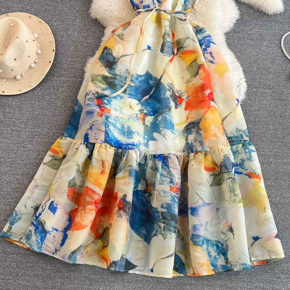 Bottom half of an abstract floral print maxi dress showing the tiered skirt and vibrant print.