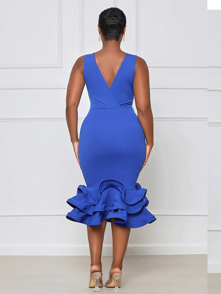 back view of a woman wearing a royal blue sleeveless v-neck dress with a ruffled mermaid hem